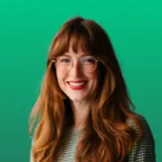 Smiling woman with red hair and glasses