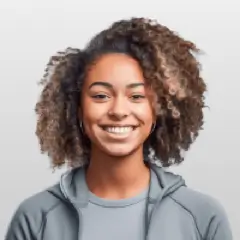 Smiling woman with curly hair wearing gray hoodie